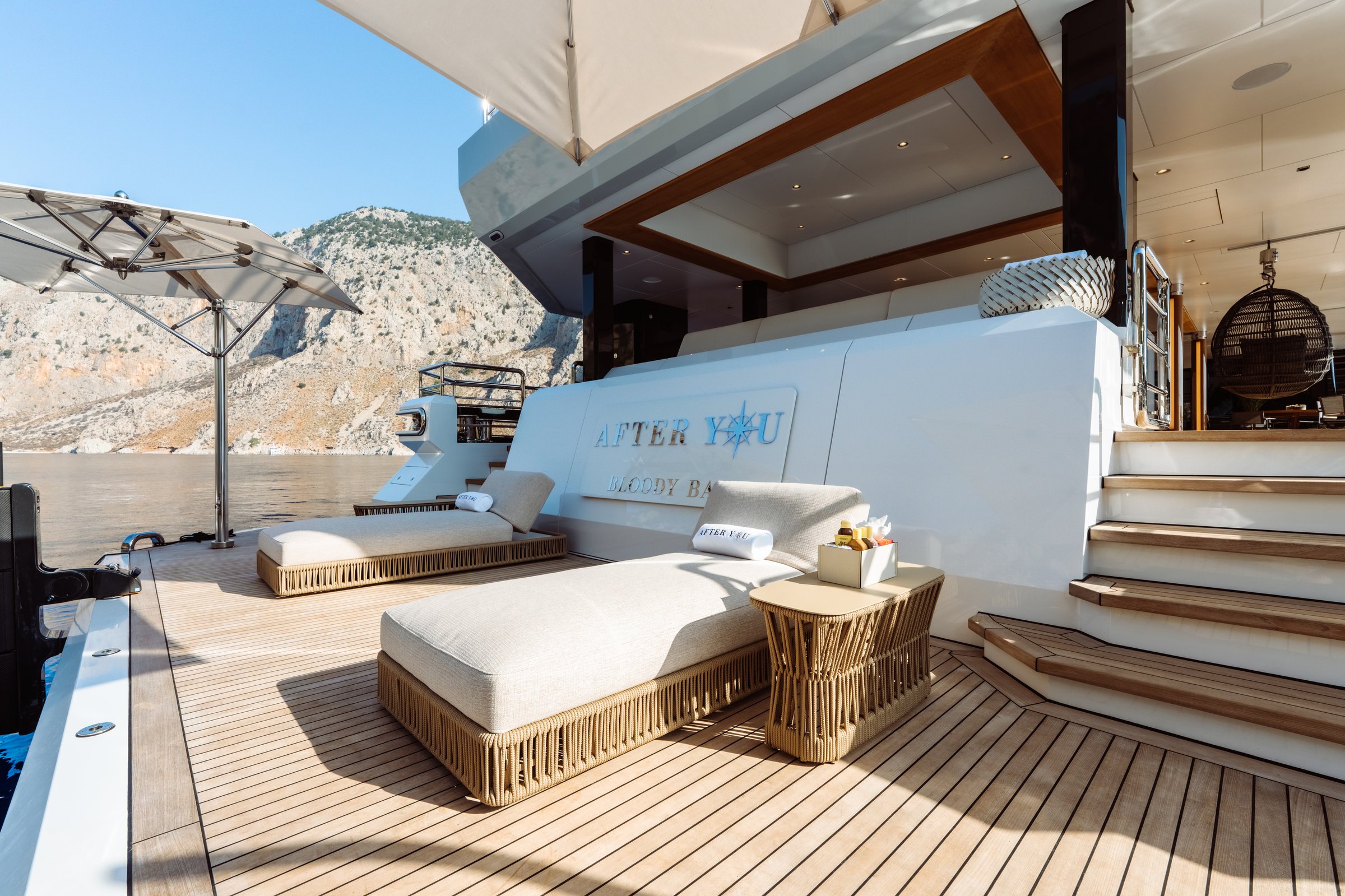 AFTER YOU — Aft beach club loungers with AFTER YOU nameplate
