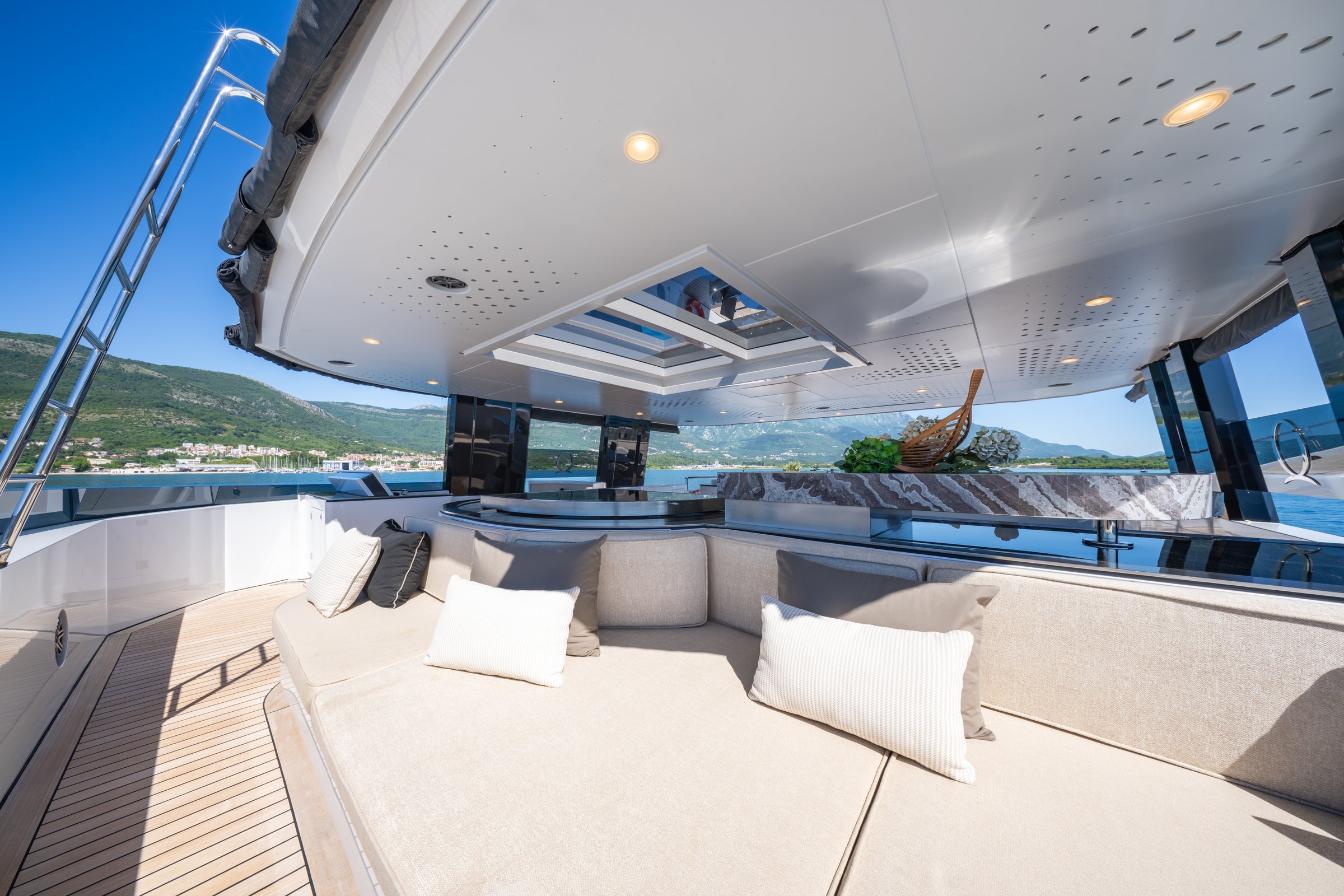Sundeck bar and seating on AQUARIUS with a glass skylight