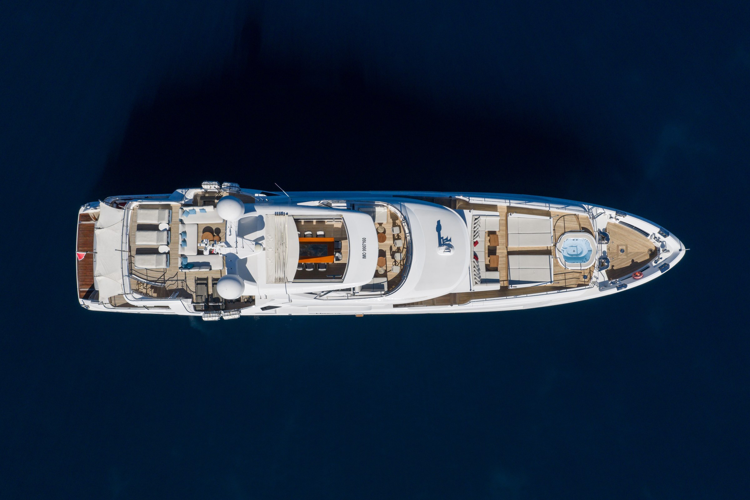 HAPPY ME — Top-down aerial of HAPPY ME decks including bow jacuzzi and aft loungers
