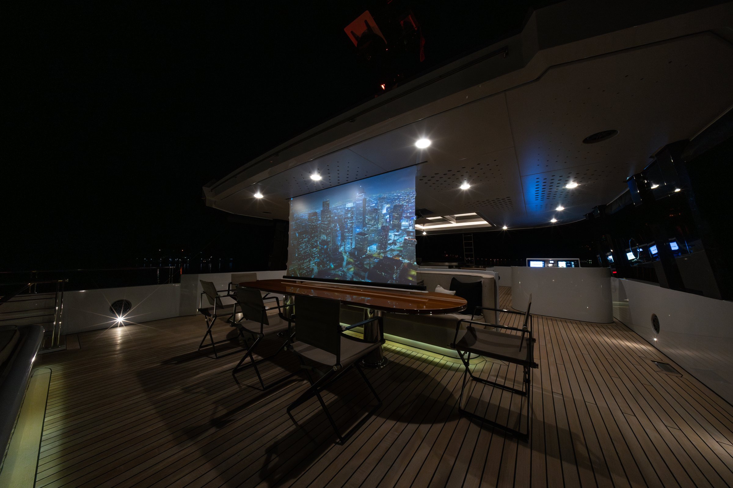 Open-air cinema screen set up on the aft deck of AQUARIUS at night