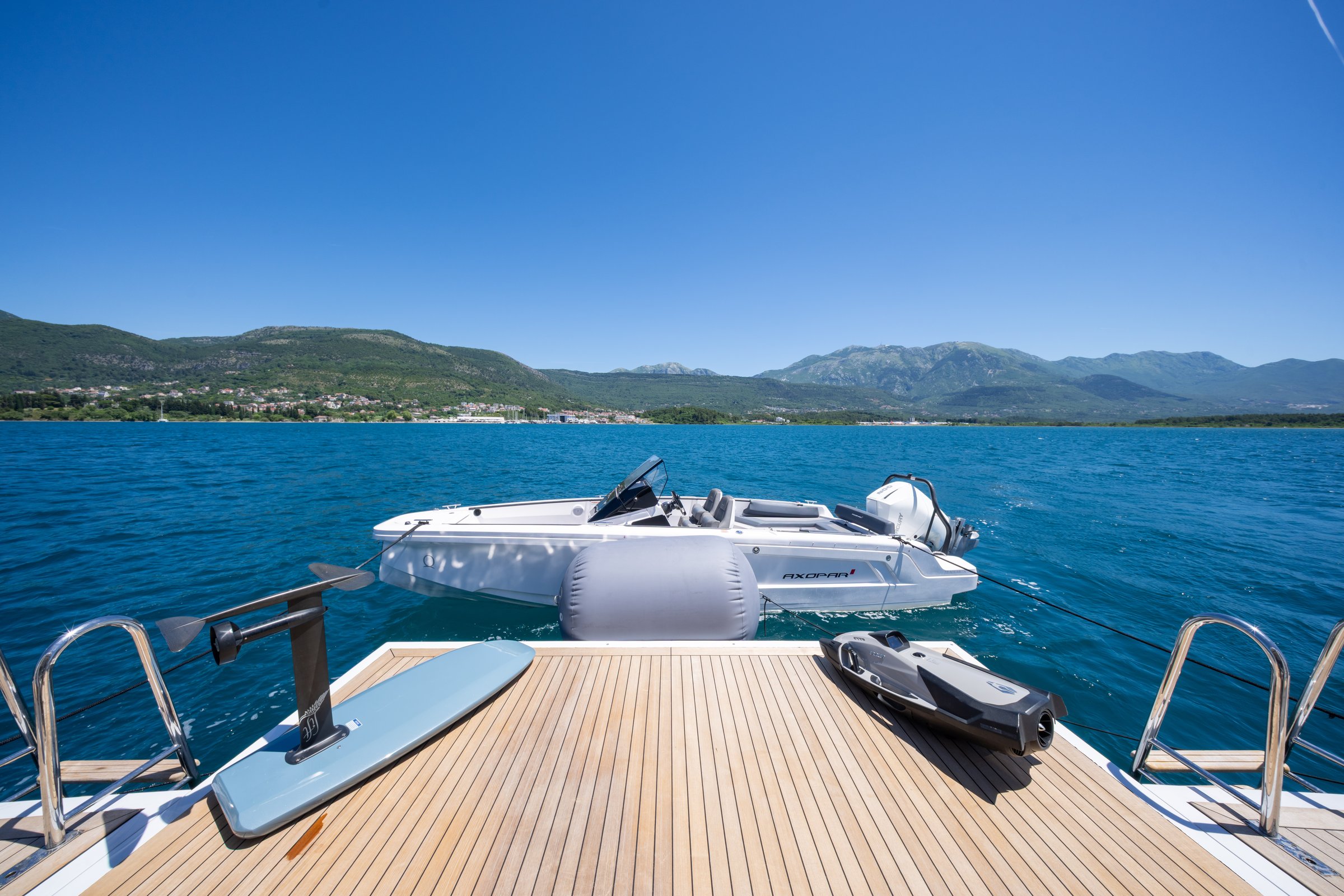 Swim platform of AQUARIUS with the Axopar chase boat, foil board and Seabob