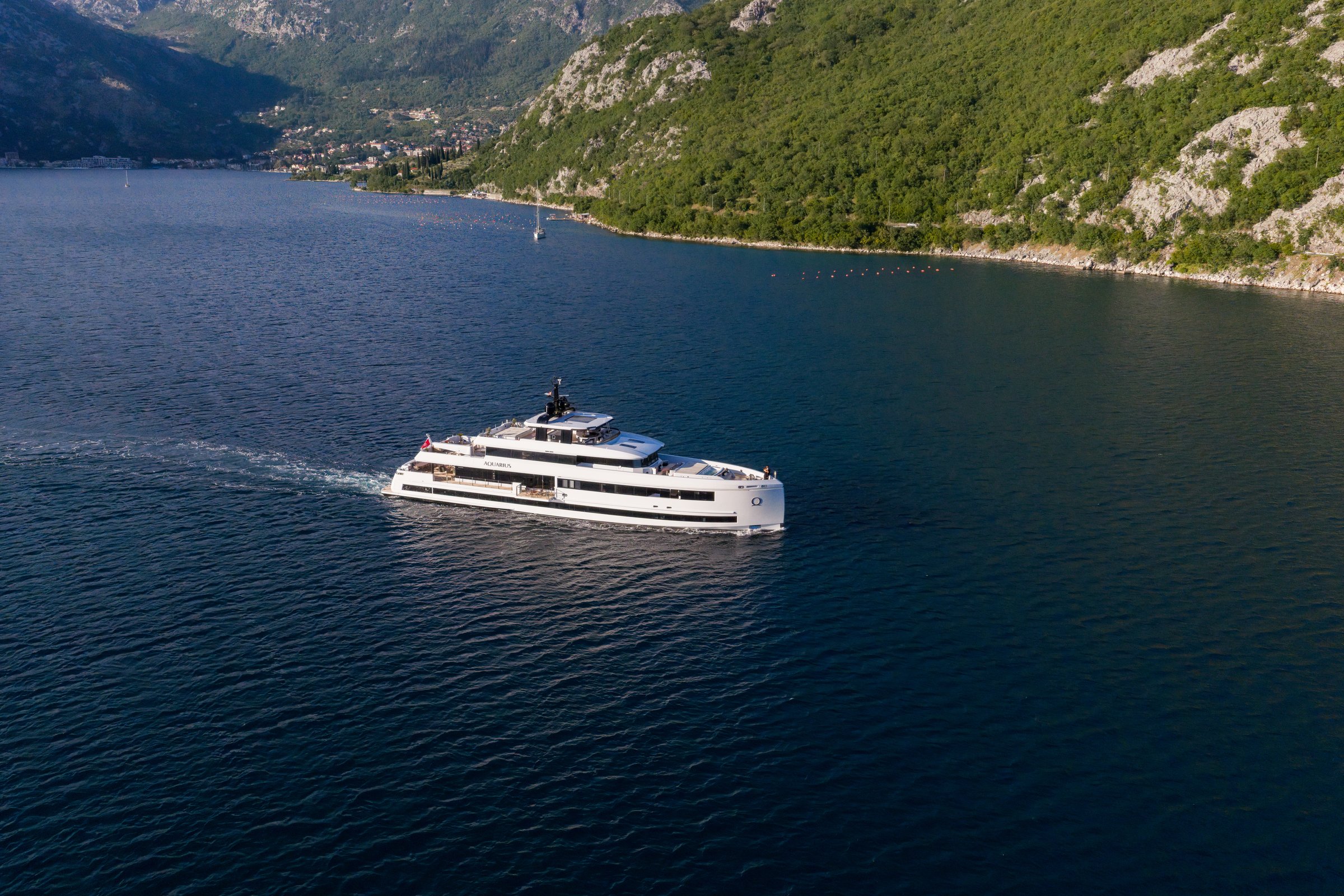 AQUARIUS cruising below the mountains of the Bay of Kotor