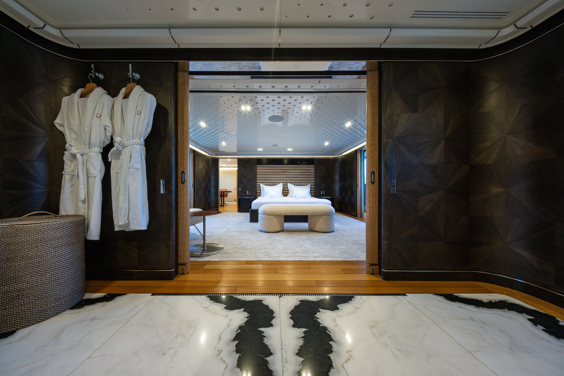 Entrance to the master suite of AQUARIUS with robes and marble flooring