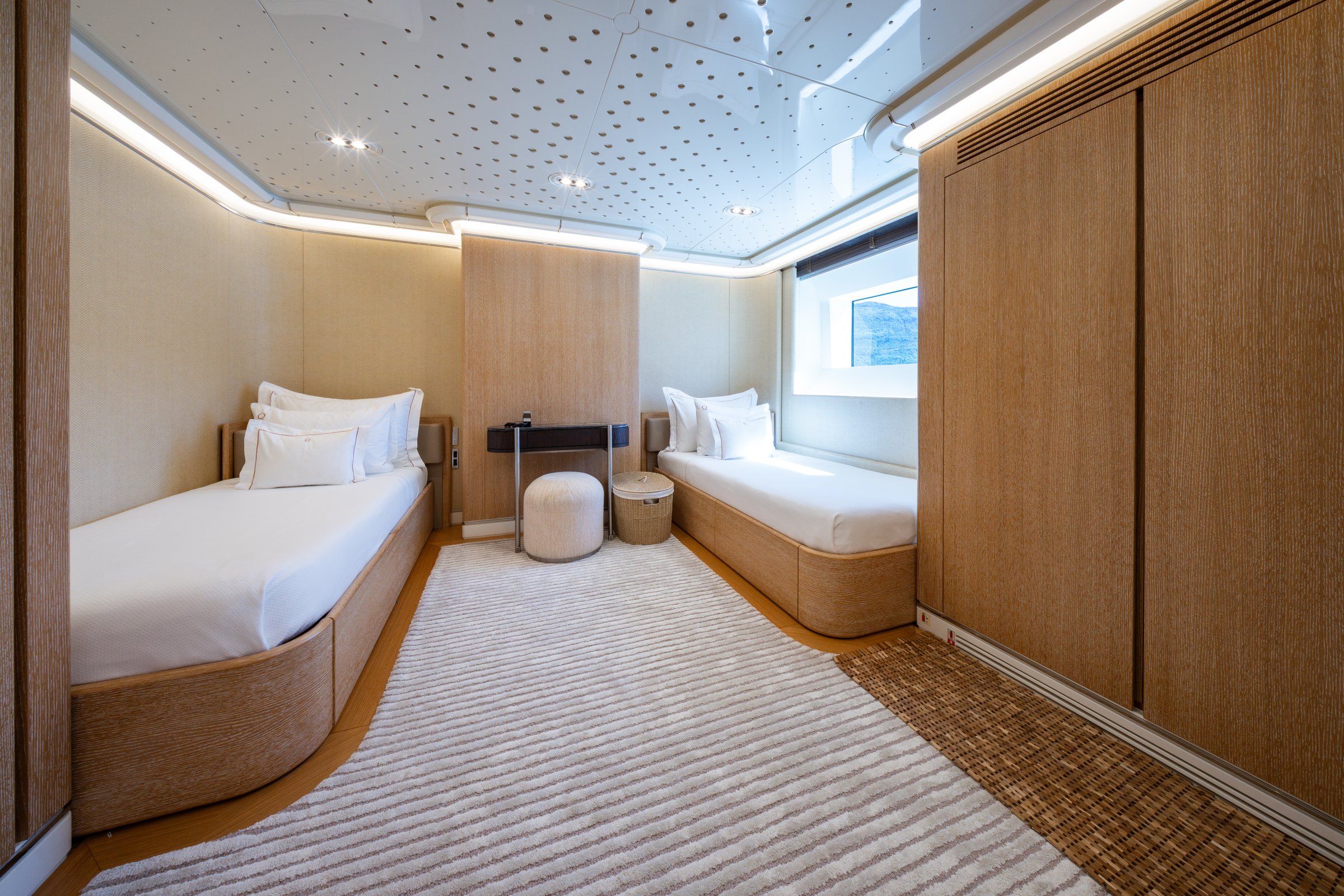 Twin guest cabin aboard AQUARIUS with two single berths and a sea-view window