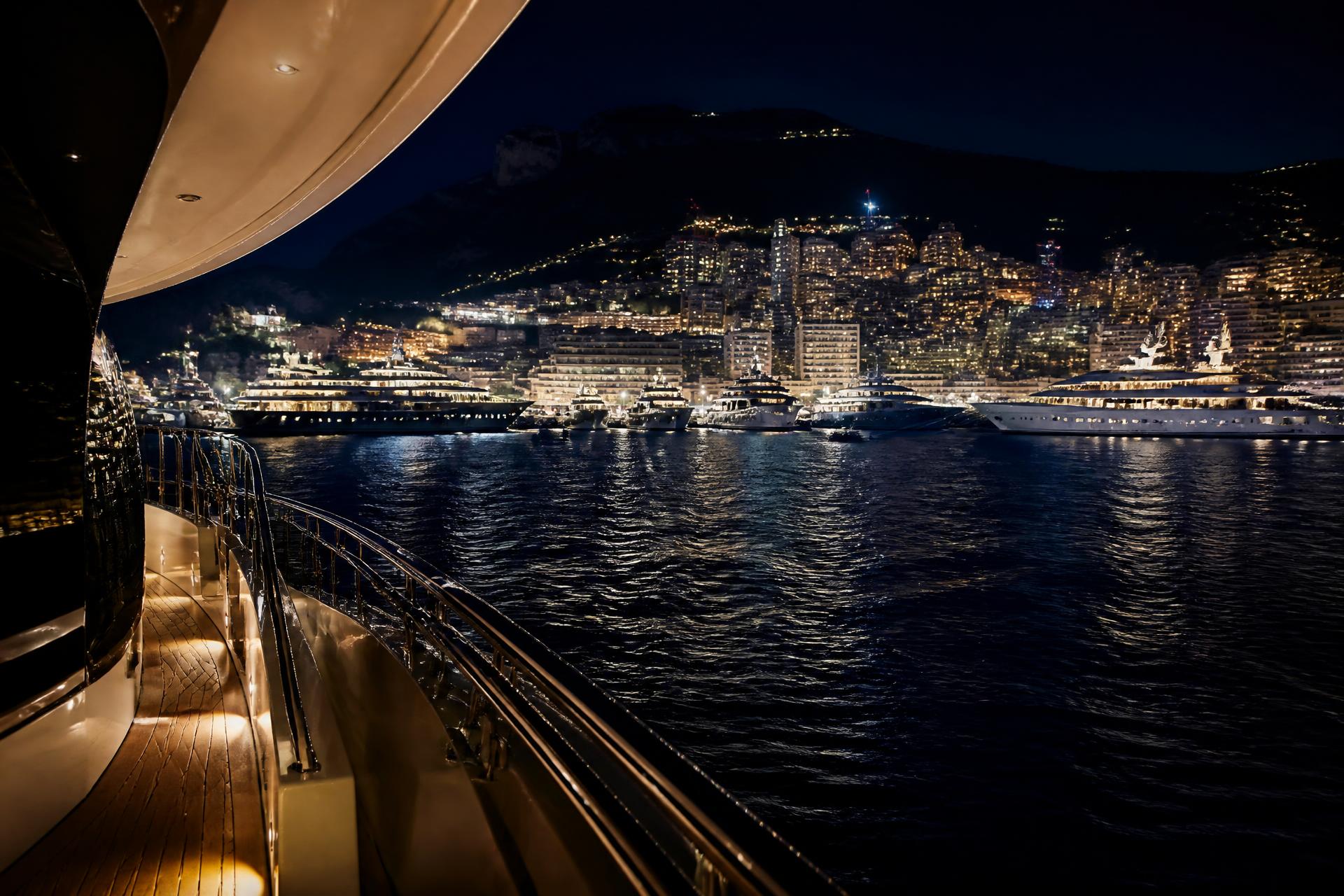 Monaco Yacht Show fleet in Port Hercule at night