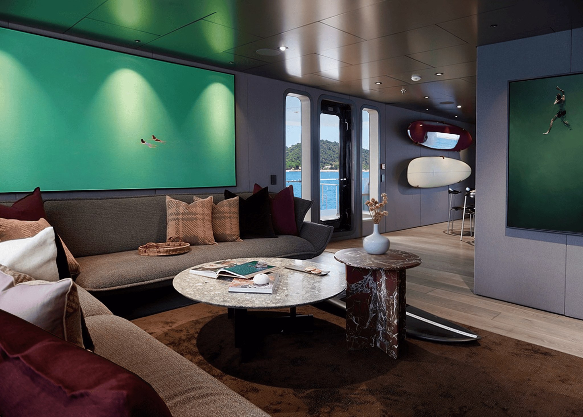 Main salon of 2B by Oceania Interiors with curved sofa, marble tables and surfboards mounted on the bulkhead