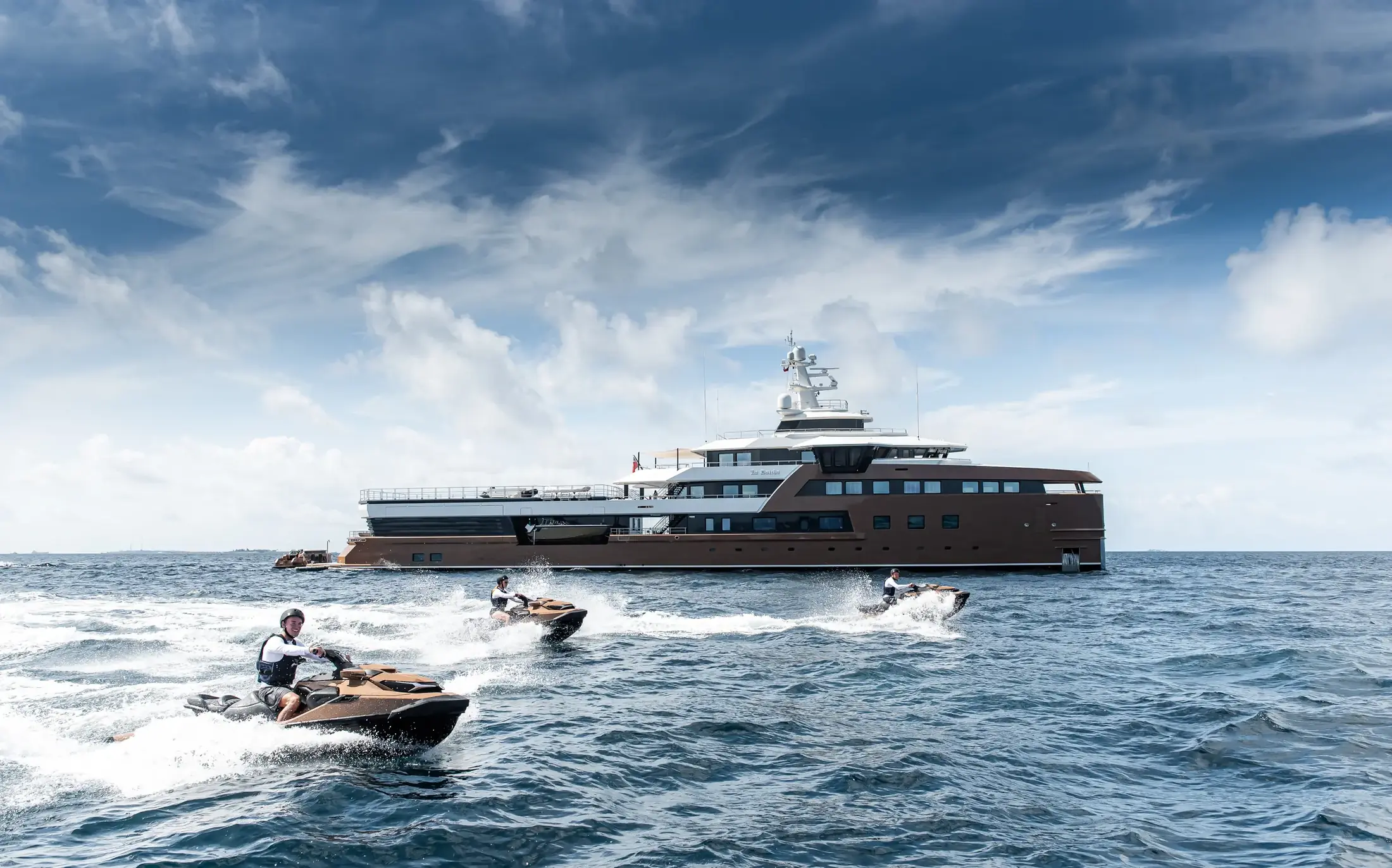 Guest riding a personal watercraft beside LA DATCHA