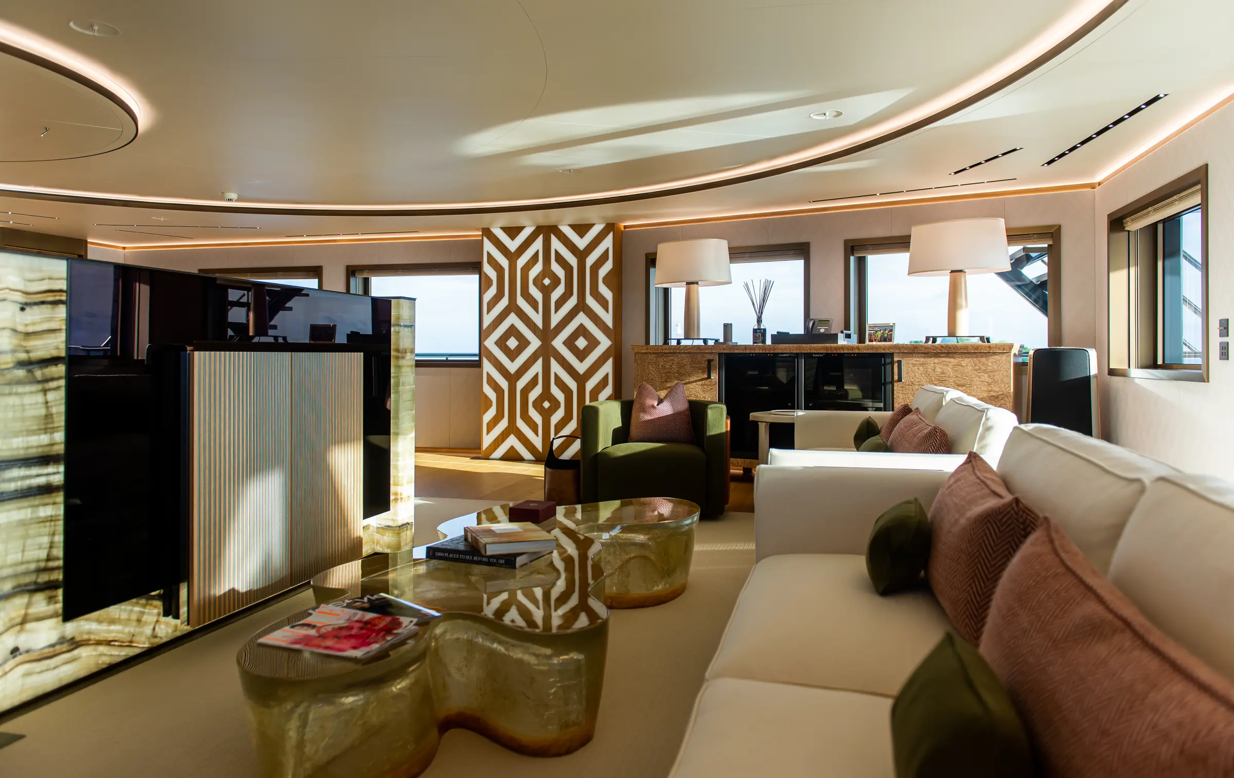 Main salon lounge aboard LA DATCHA with geometric illuminated panels