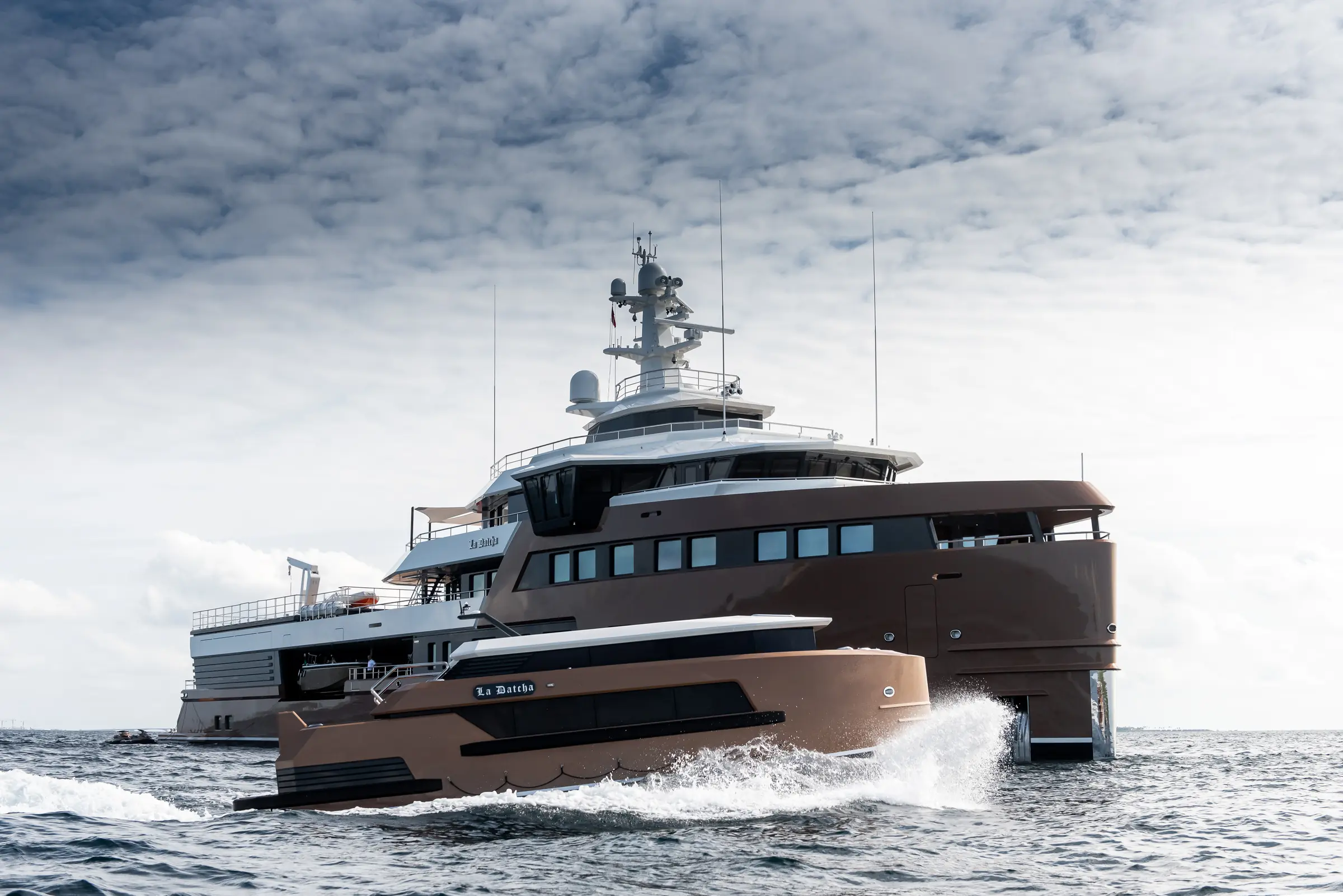 LA DATCHA stern-quarter view with an expedition tender under way
