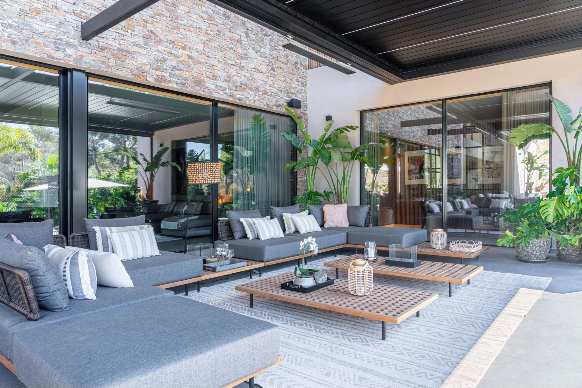 Covered terrace seating facing the pool at the Cala Vinyas villa