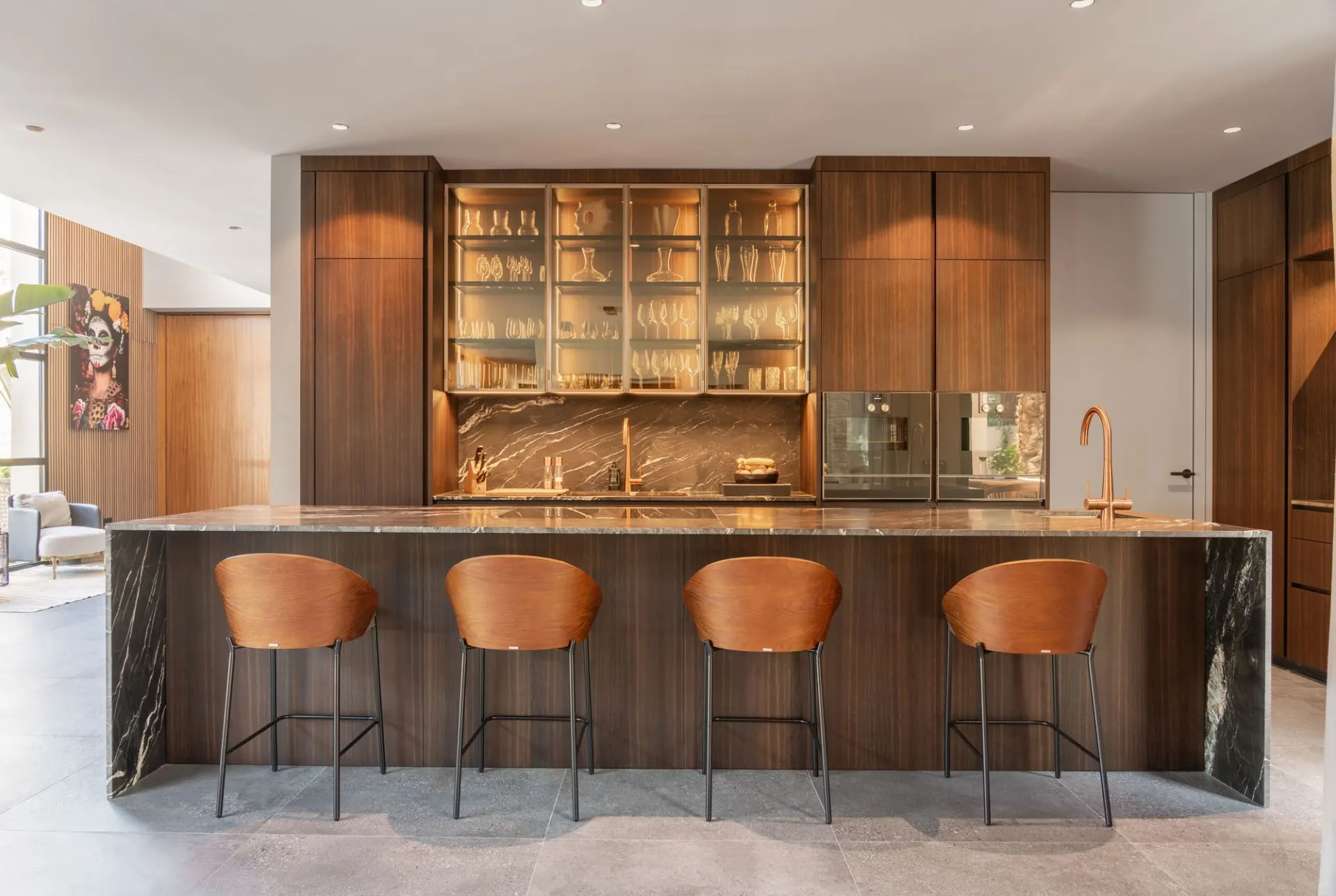 Kitchen island and pale cabinetry in the Cala Vinyas villa, with the dining area beyond